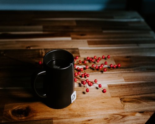 A warm mug resting on a wooden table